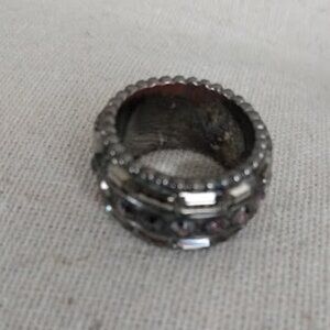 Reverse B R: Ring with glass stones.